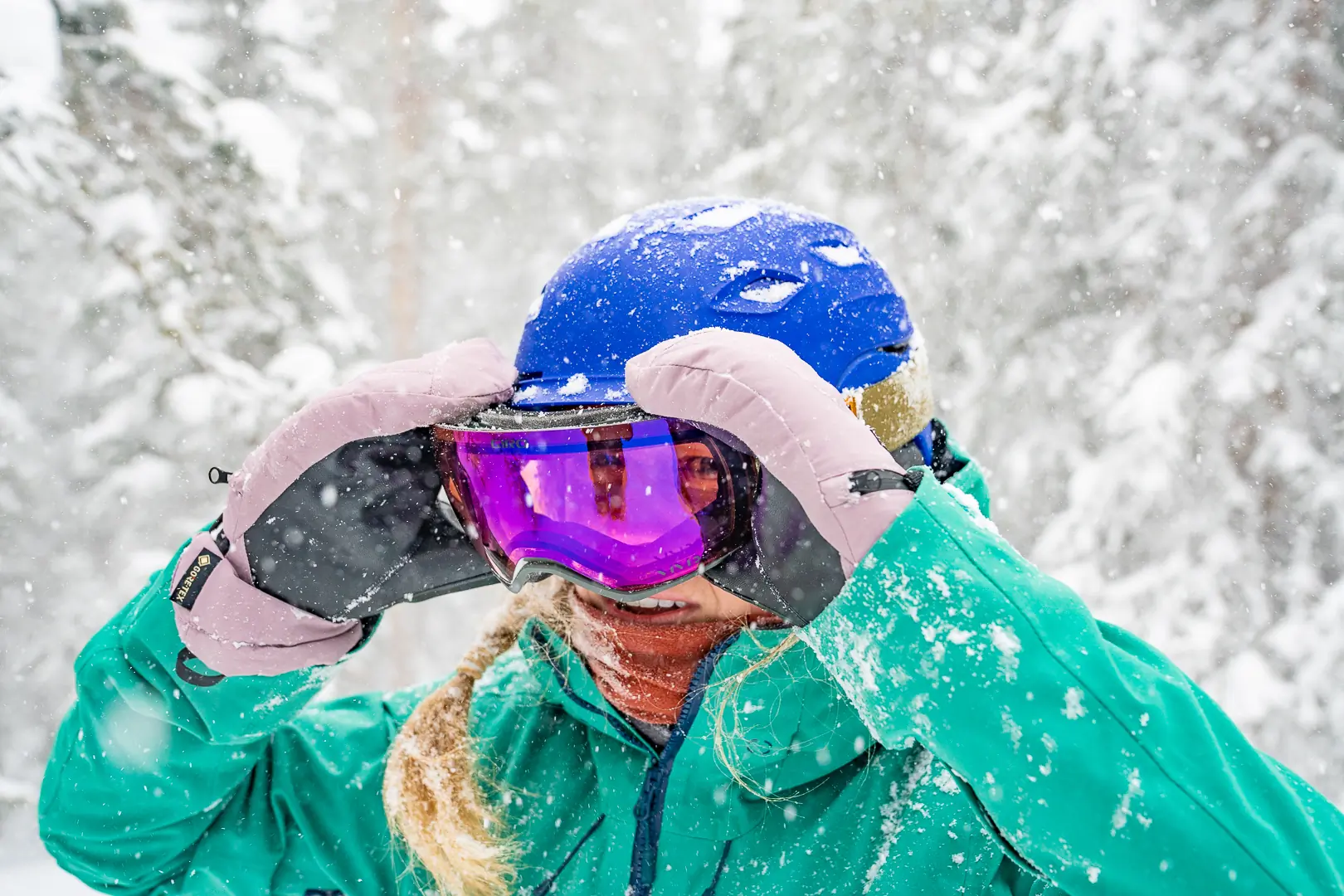 woman pulling goggles off face