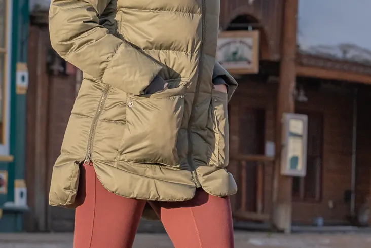 square insulated front hand pockets with snap flaps on a women's winter jacket 