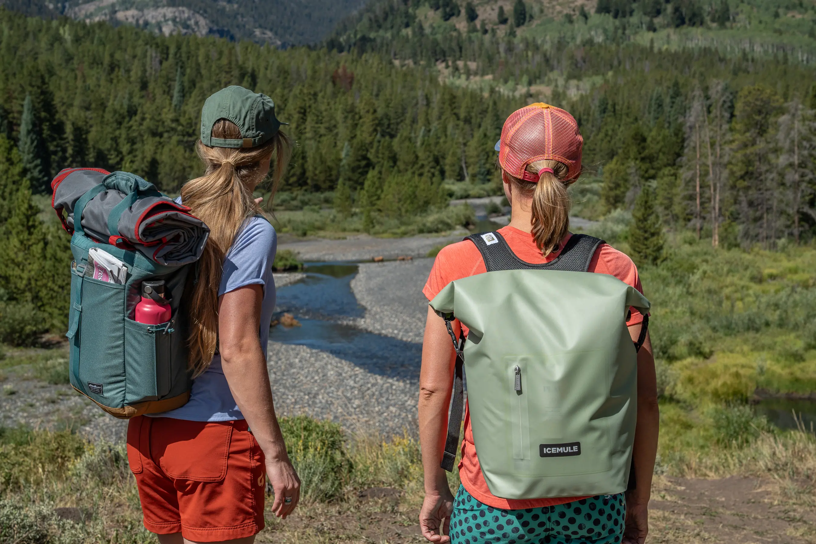 two women looking out across river bend