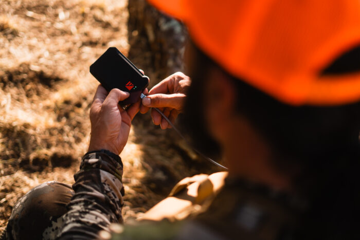 Person connecting their phone to the poseidon nano portable power bank