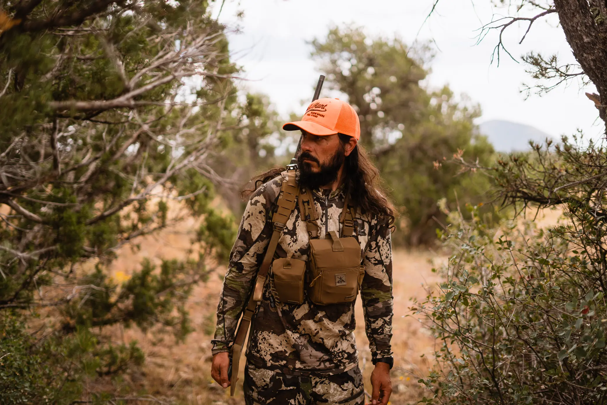 Hunter walking through the forest wearing a full hunting equipment