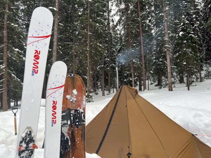 Tent and skis in snow