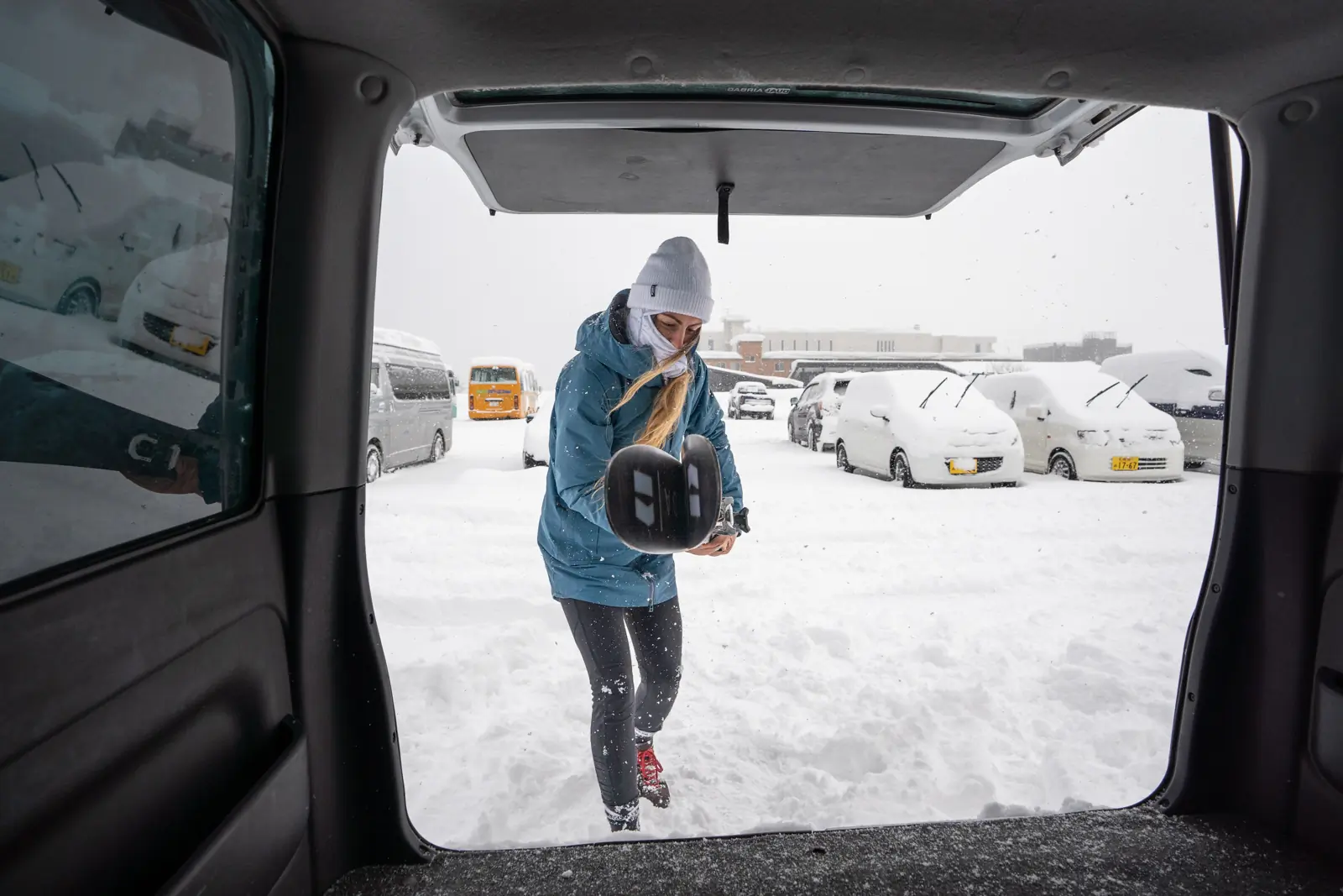 Person loading skies into a car, which makes moving around Niseko much easier.