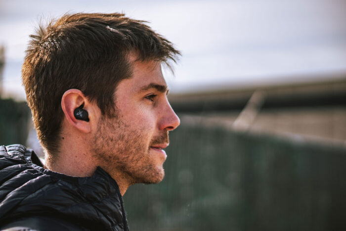 dryrobe a man wears a jaybird vista earbud in one ear