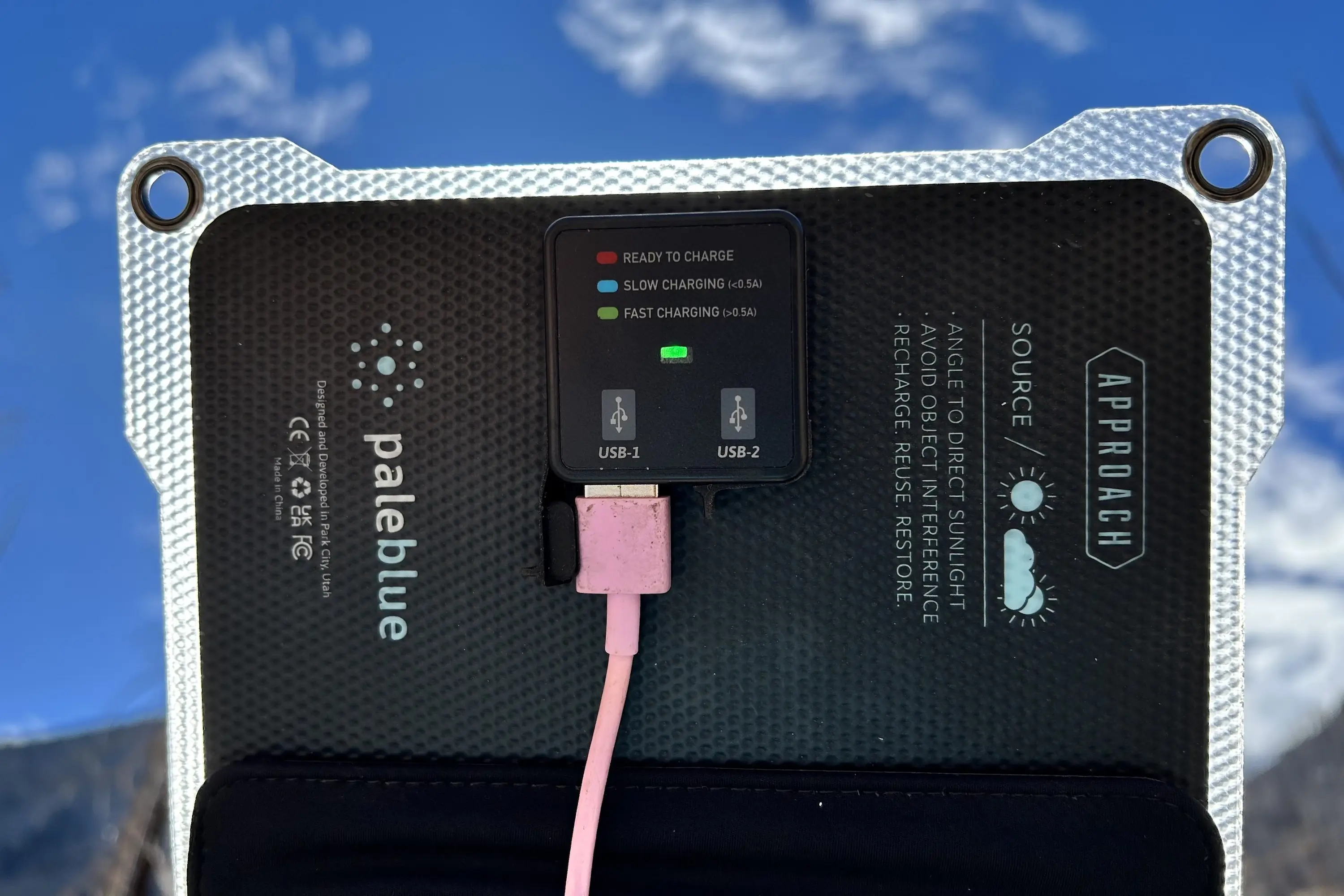 the pale blue earth Approach solar panel facing the sun with the green charging light visible