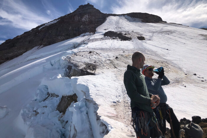 climbing team drinking water while setting up a team -North Cascades Mount Rainier National Park
