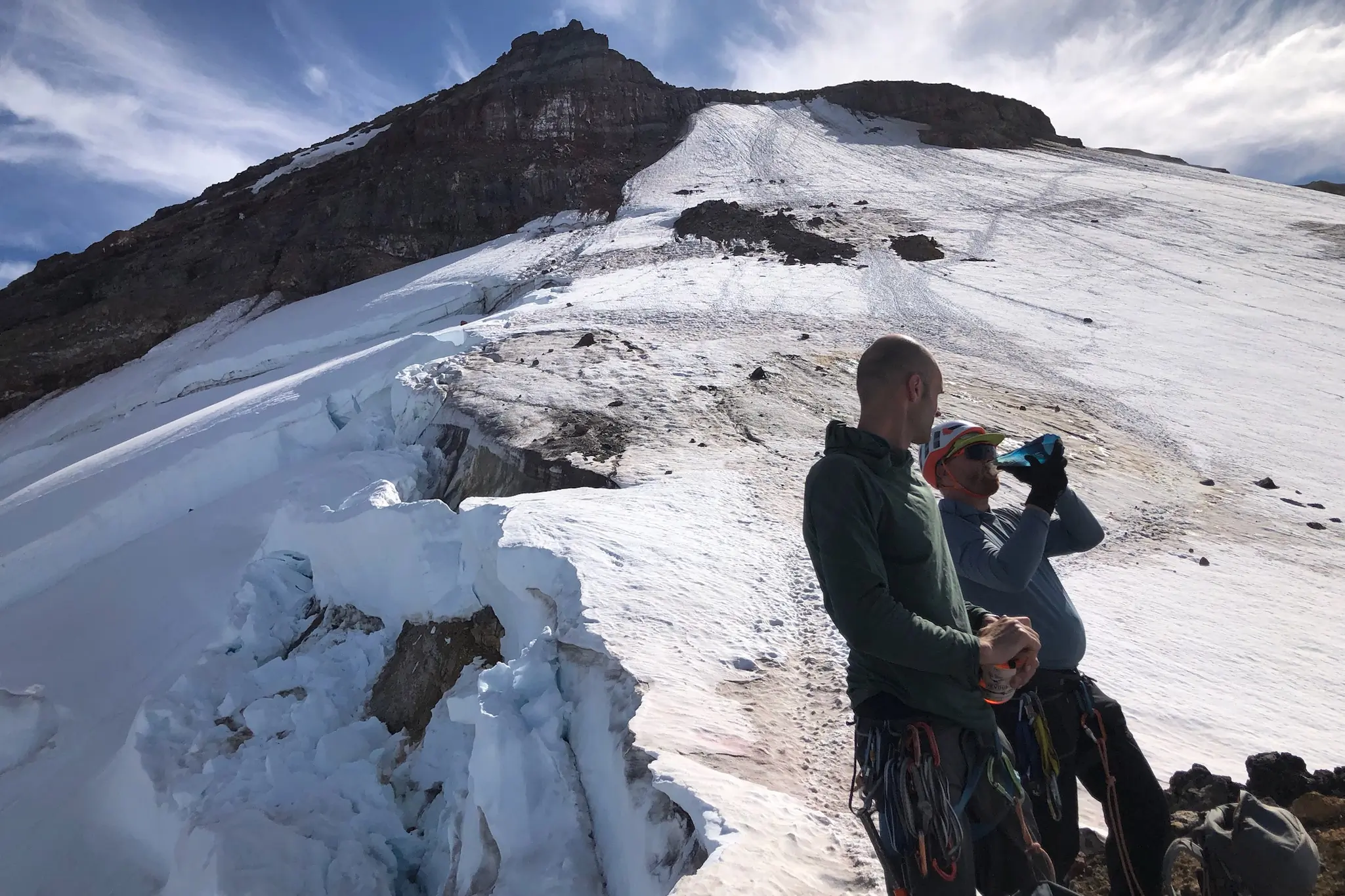 climbing team drinking water while setting up a team -North Cascades Mount Rainier National Park