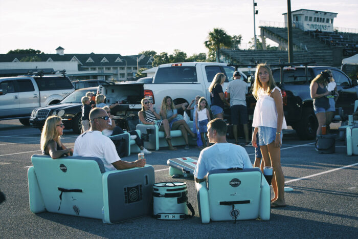 a group of people sit on inflatable camp furniture 