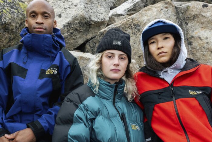 Three people pose with three variations on Mountain Hardwear's reissued clothing