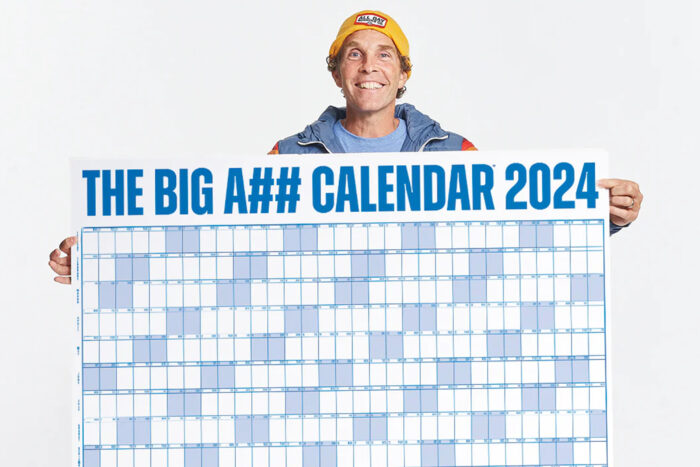 Giv'r Gloves a man holds a big A## calendar between two outstretched hands