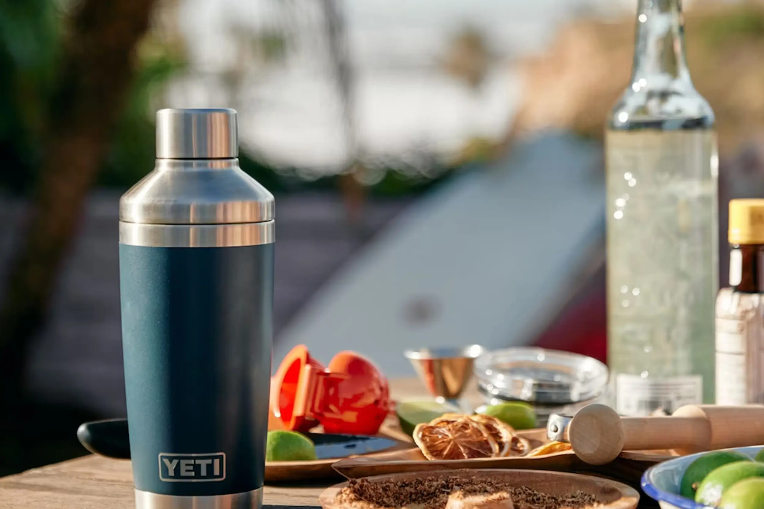 a yeti rambler cocktail shaker sits on a table with drink makings