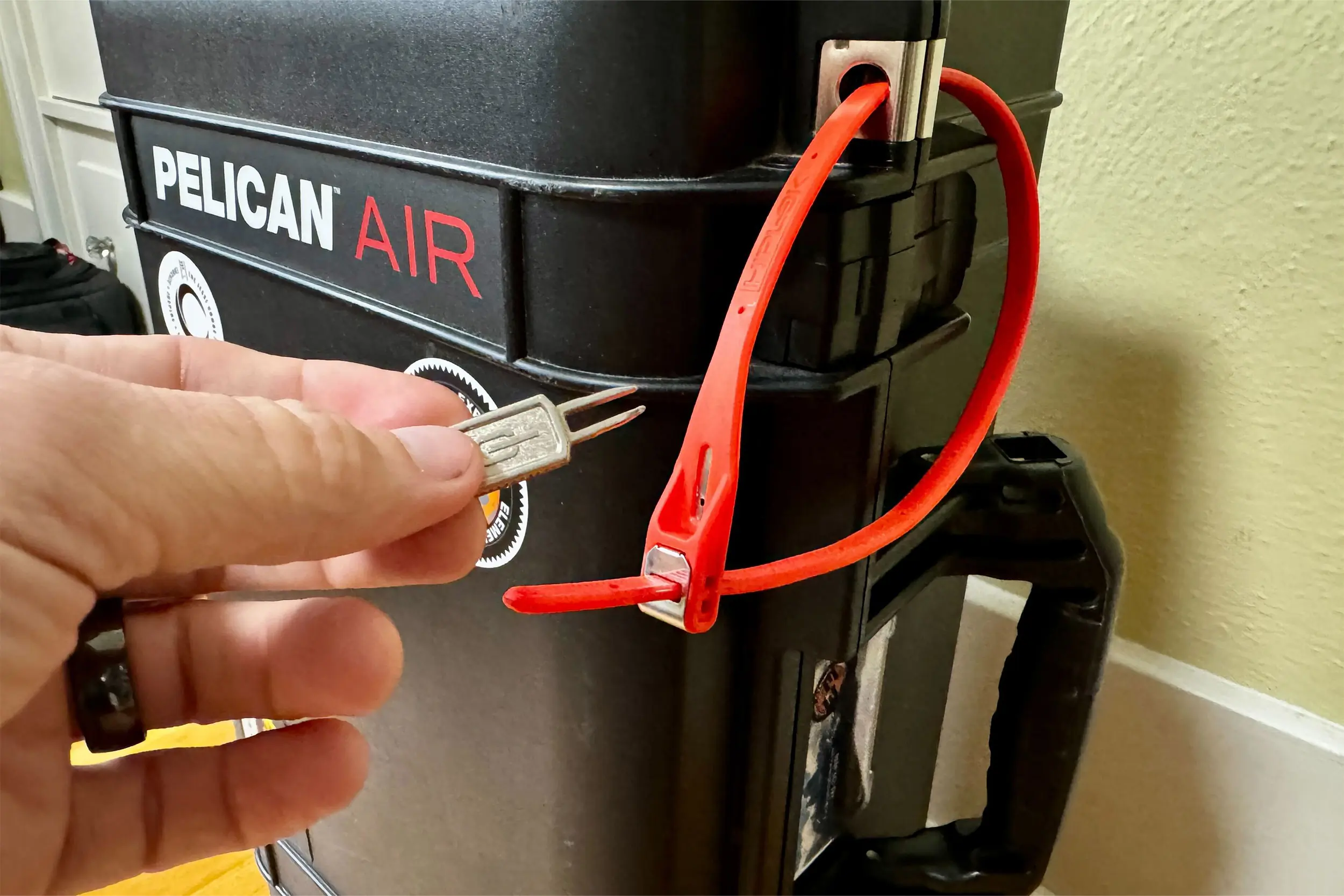 a hand unlocks a hiplok z lok security tie