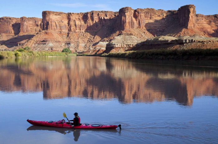 Kayaker paddles on the Green River in Moab