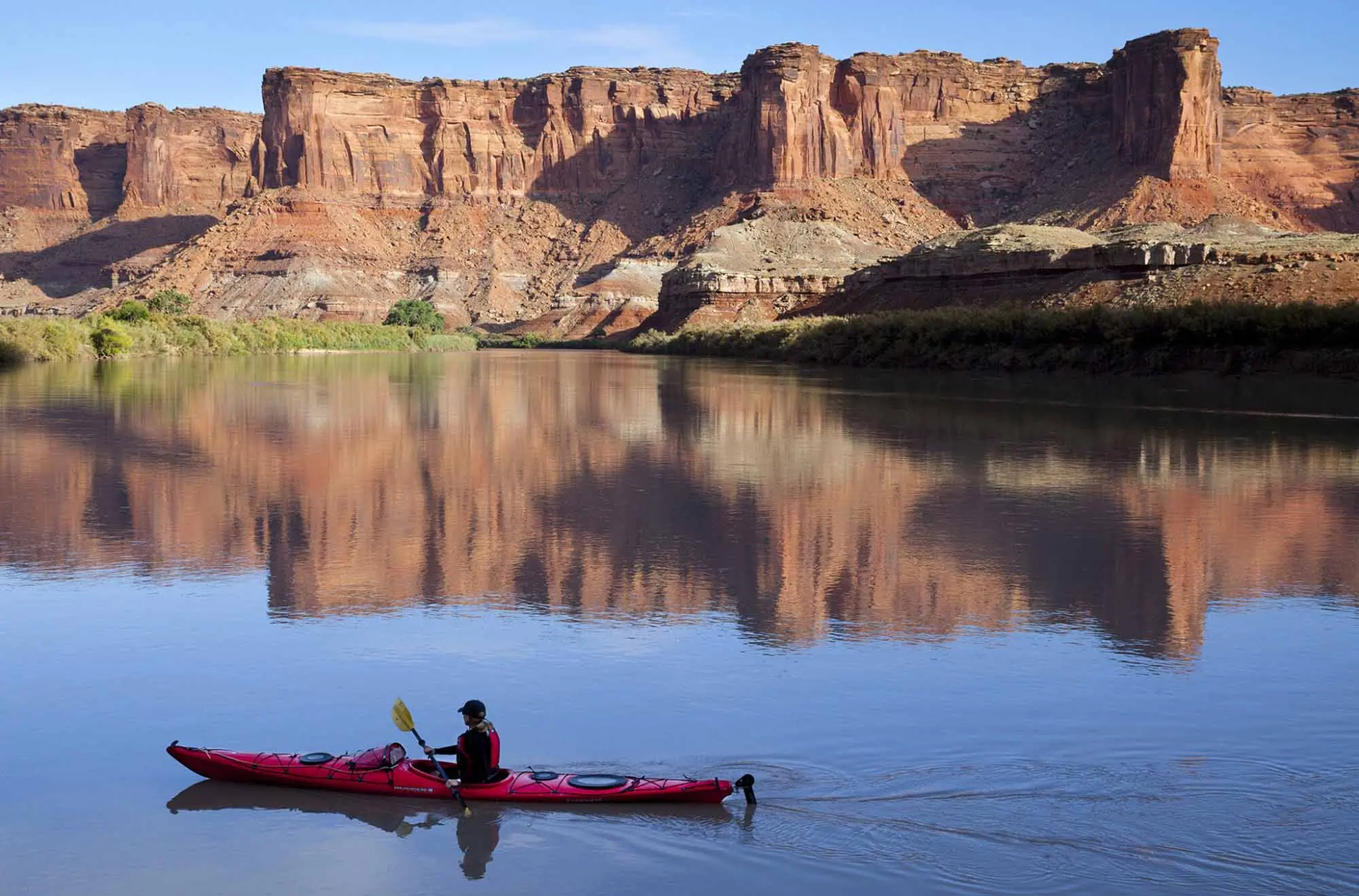 Kayaker paddles on the Green River in Moab