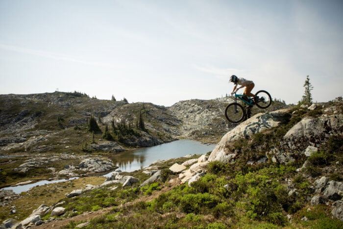 bkier with mountain bike going downhill