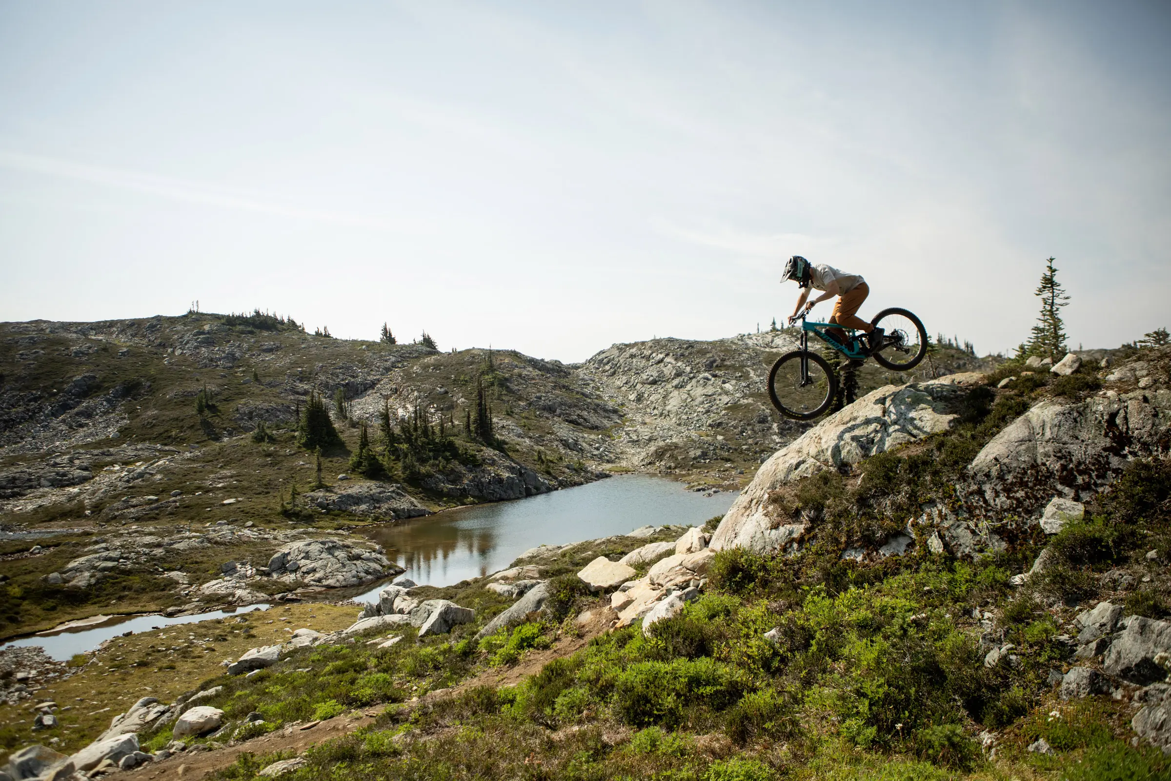 bkier with mountain bike going downhill