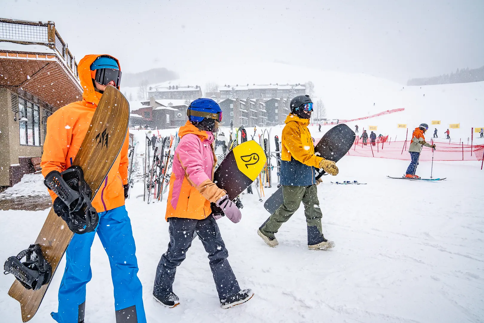 three snowboarders walking out of base area at CBMR 