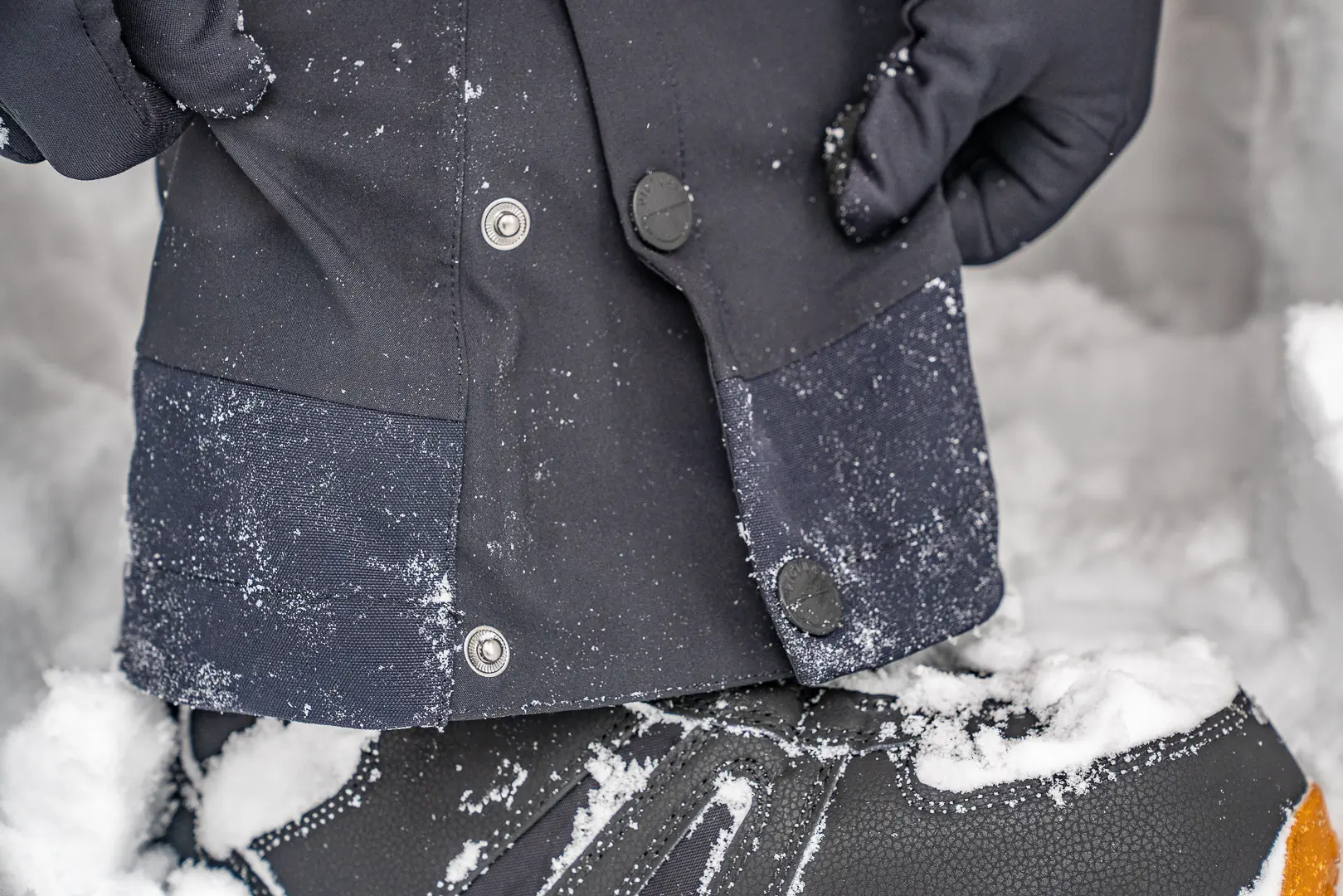 snaps on lower leg hem close or open to expand circumference on snow bibs