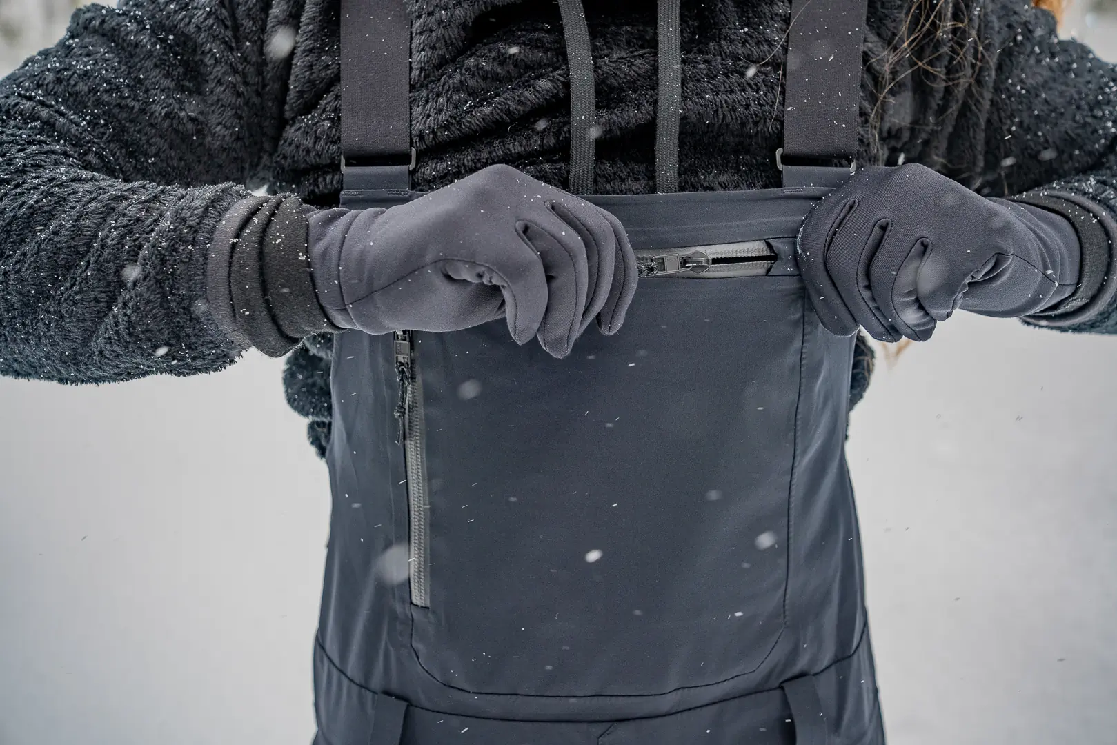 unzipping front chest zipper on women's snowboard bibs