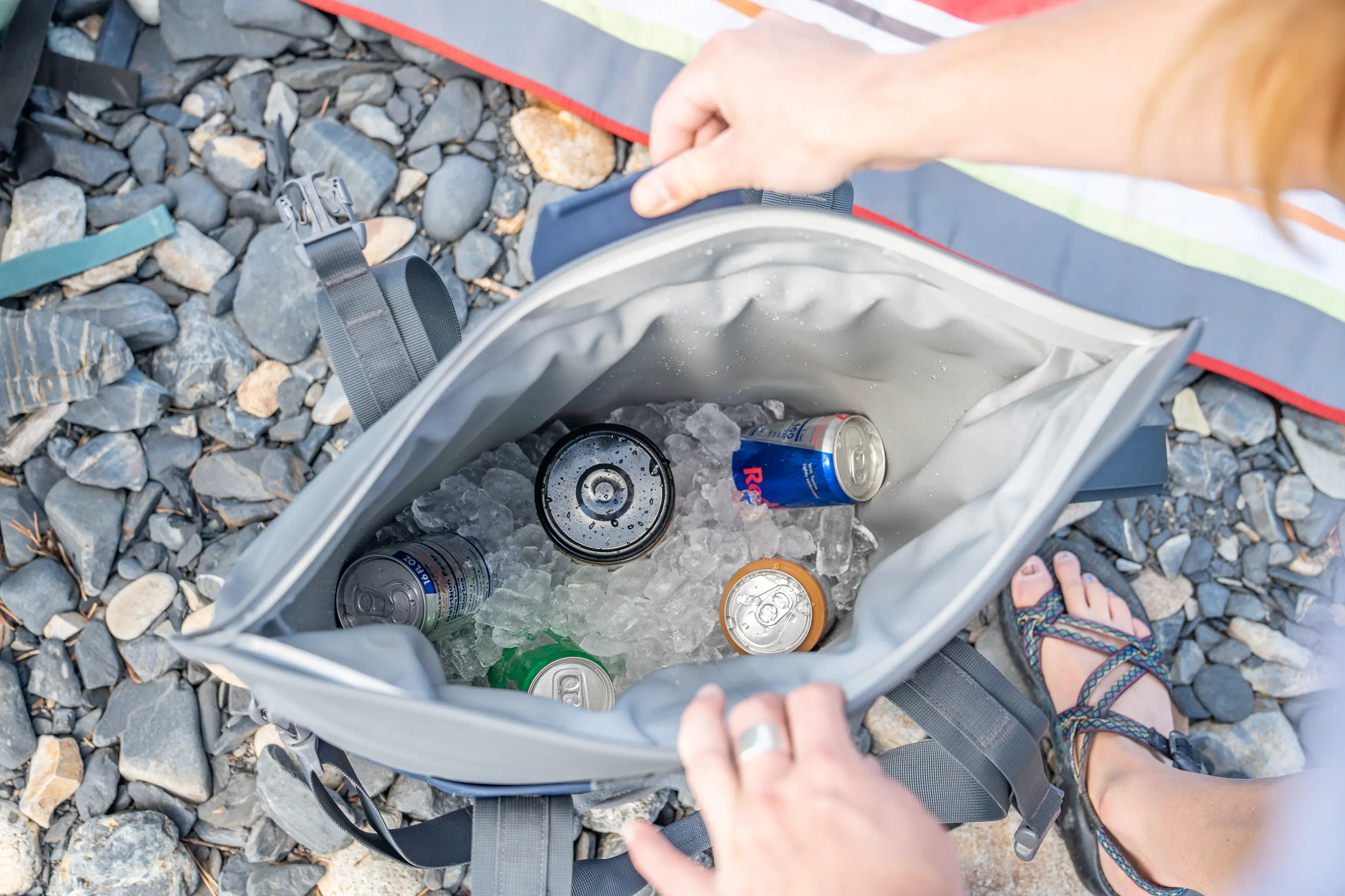 opening up soft cooler tote to see drinks inside on ice 