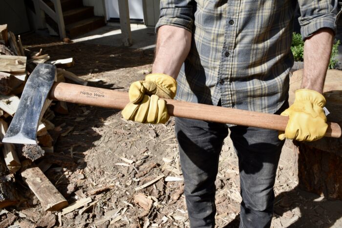 a man demonstrating the helko werk traditional nordic splitting axe