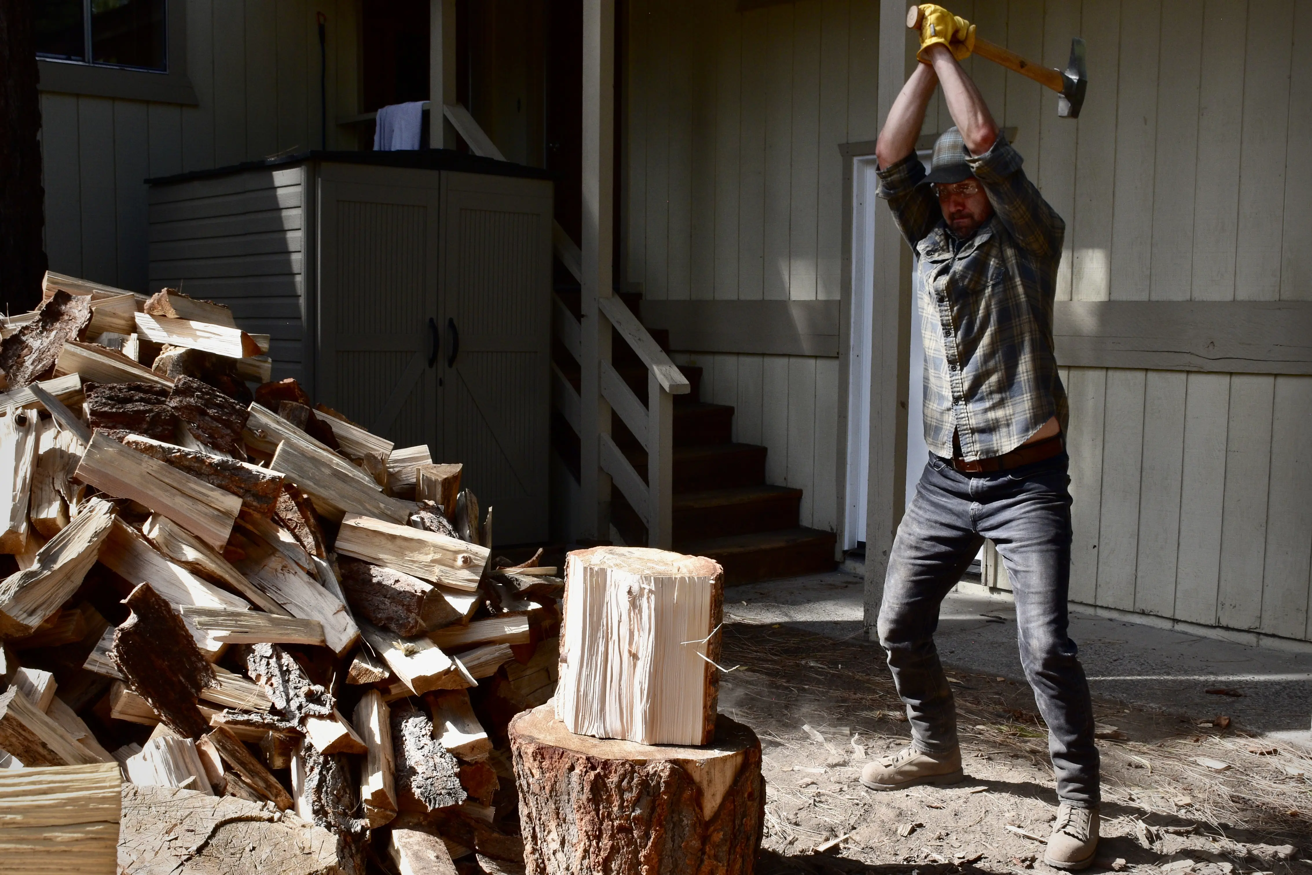 a man splitting wood with an axe