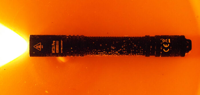 The Nitecore MT2A Pro sits in a bucket of water in testing