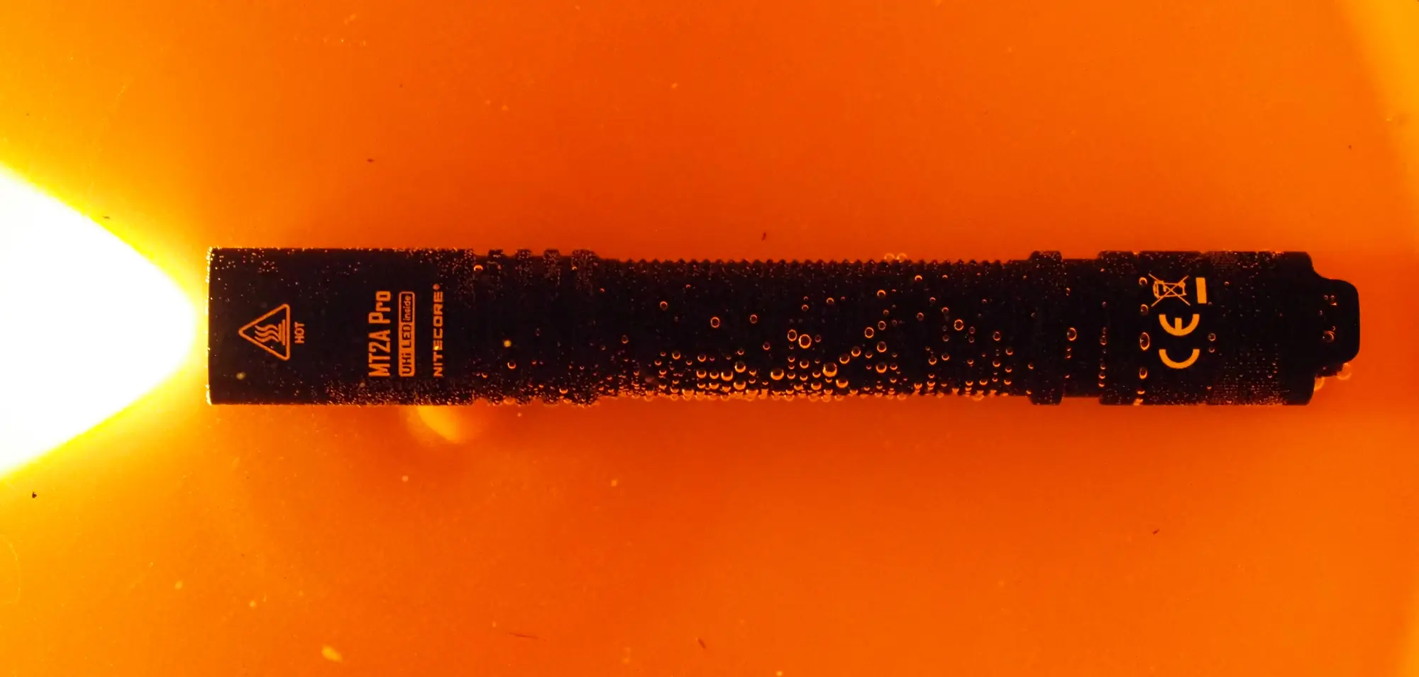 The Nitecore MT2A Pro sits in a bucket of water in testing