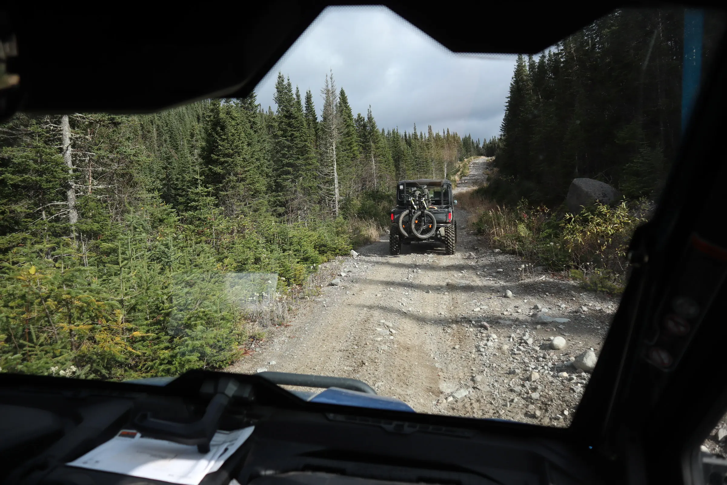 Author inside an UTV going through a mountain biking path