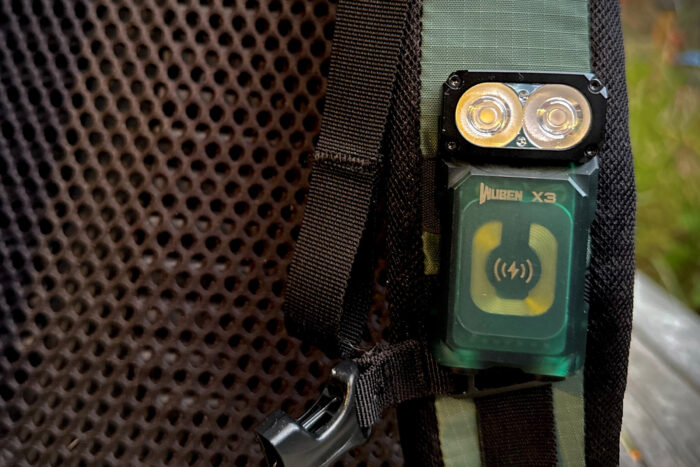Wuben X3 magnetic flashlight strapped to a backpack