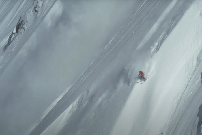 A skier descends a steep slope