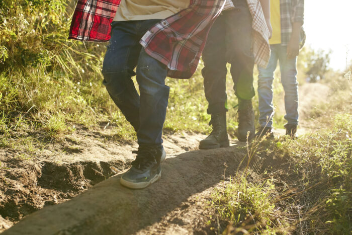a group of children walk along a trail