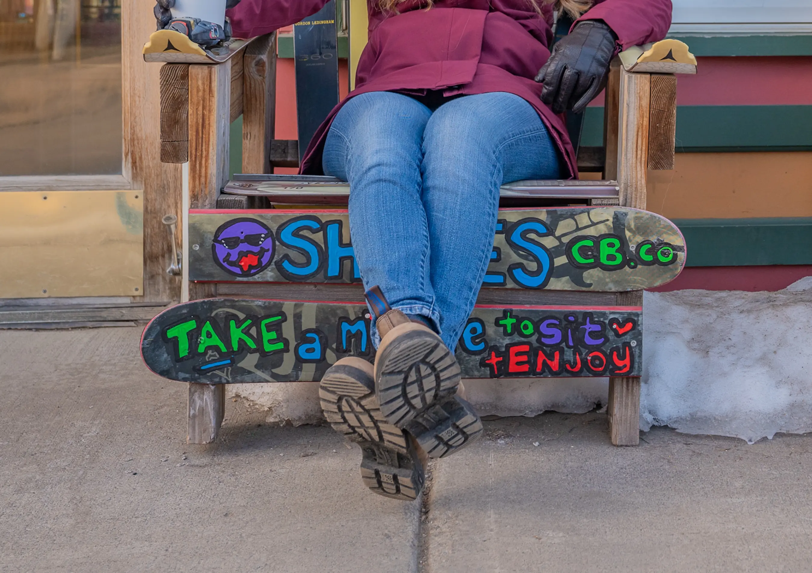 testing women's winter boots while sitting on a bench wearing blundstones 