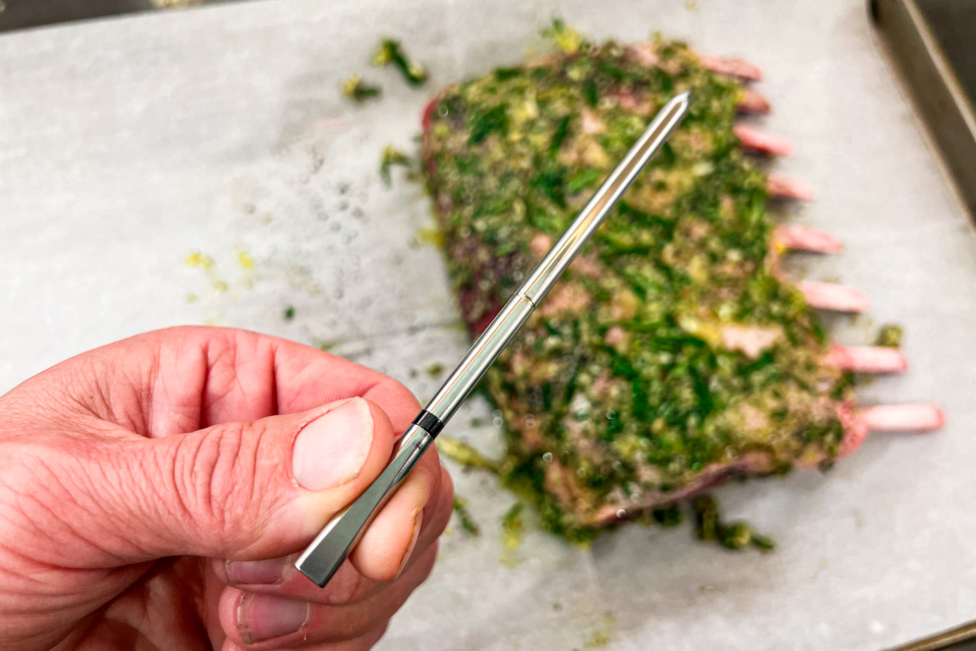 The MEATER 2 Plus in use cooking a rack of lamb;