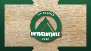 a GearJunkie green logo with a mountain and the text "top stories of 2023" on a wooden background