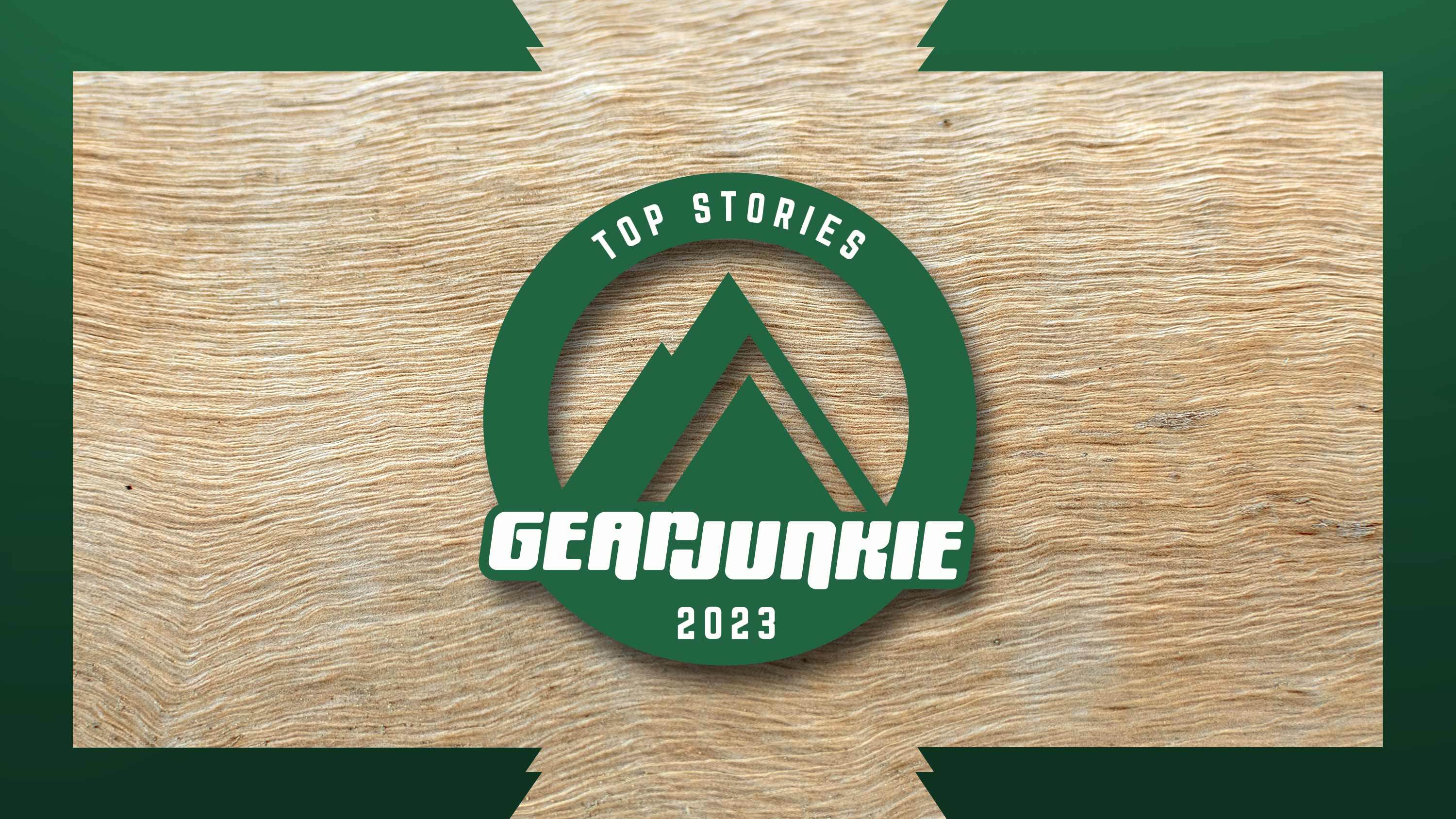 a GearJunkie green logo with a mountain and the text "top stories of 2023" on a wooden background
