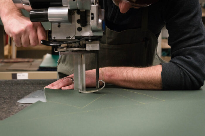 a worker constructs a Duluth Pack