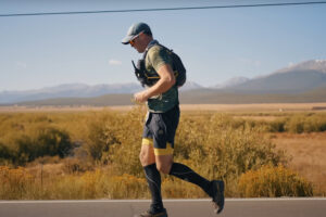 a man runs along a road in Colorado