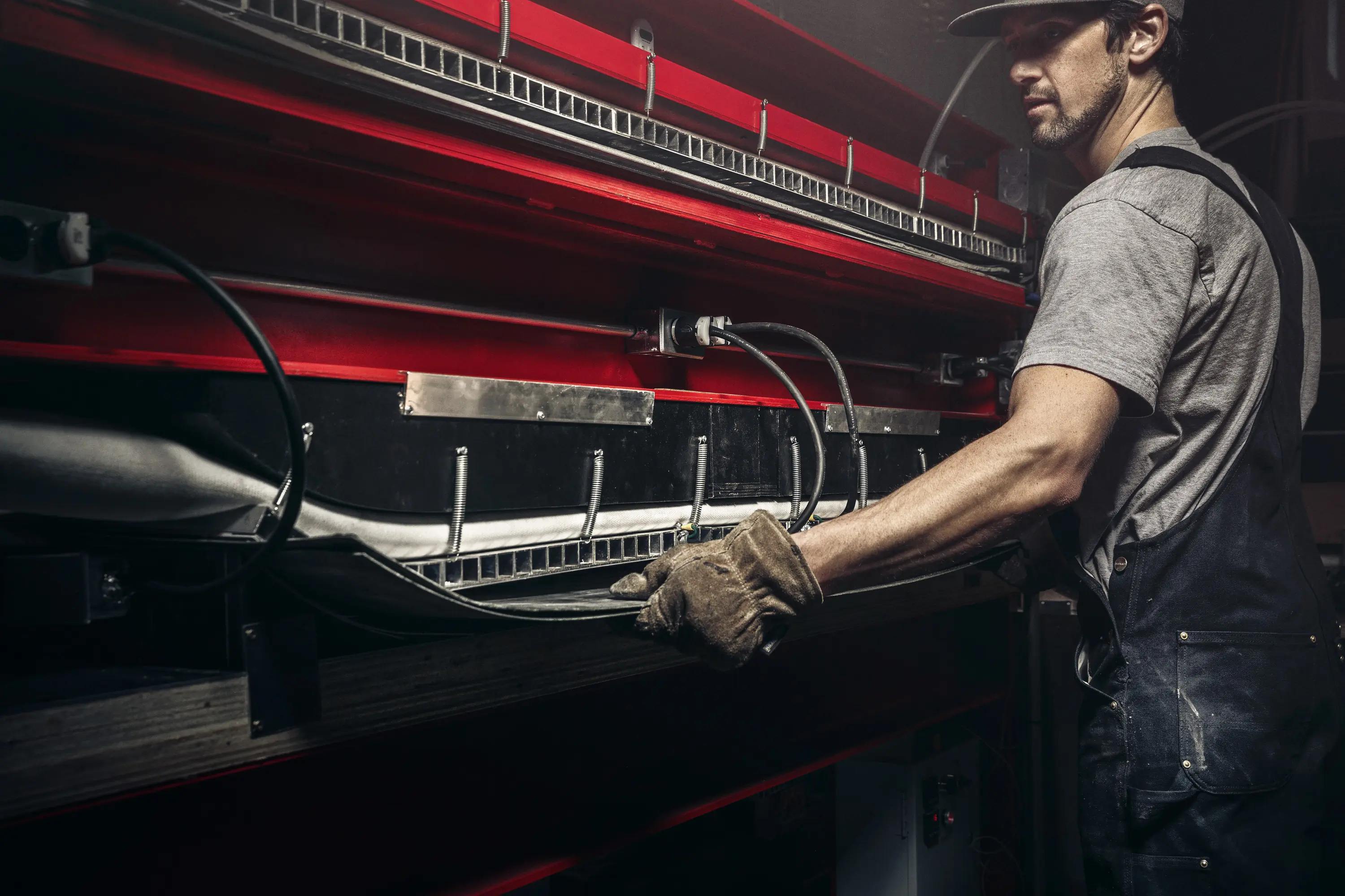 Nicol working on a SnoPlank in the Bend, Oregon shop
