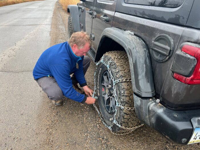 Installing tire chains on a jeep