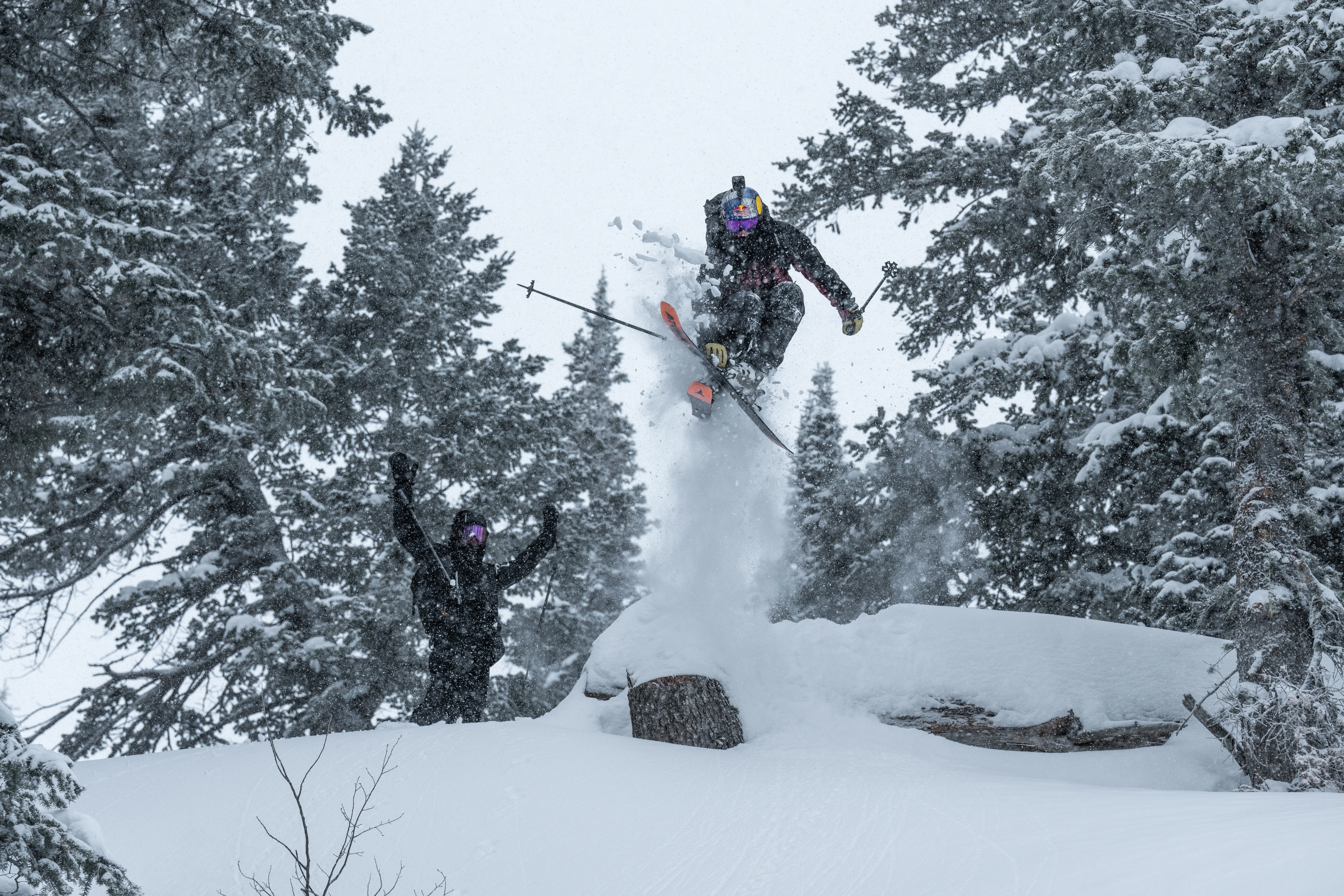 A skier jumps over a cliff at Powder Mountain