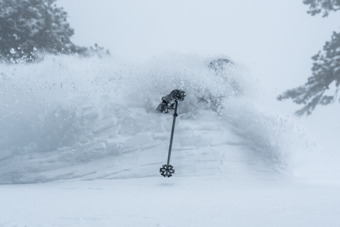 Snow flows over a skier at Powder Mountain