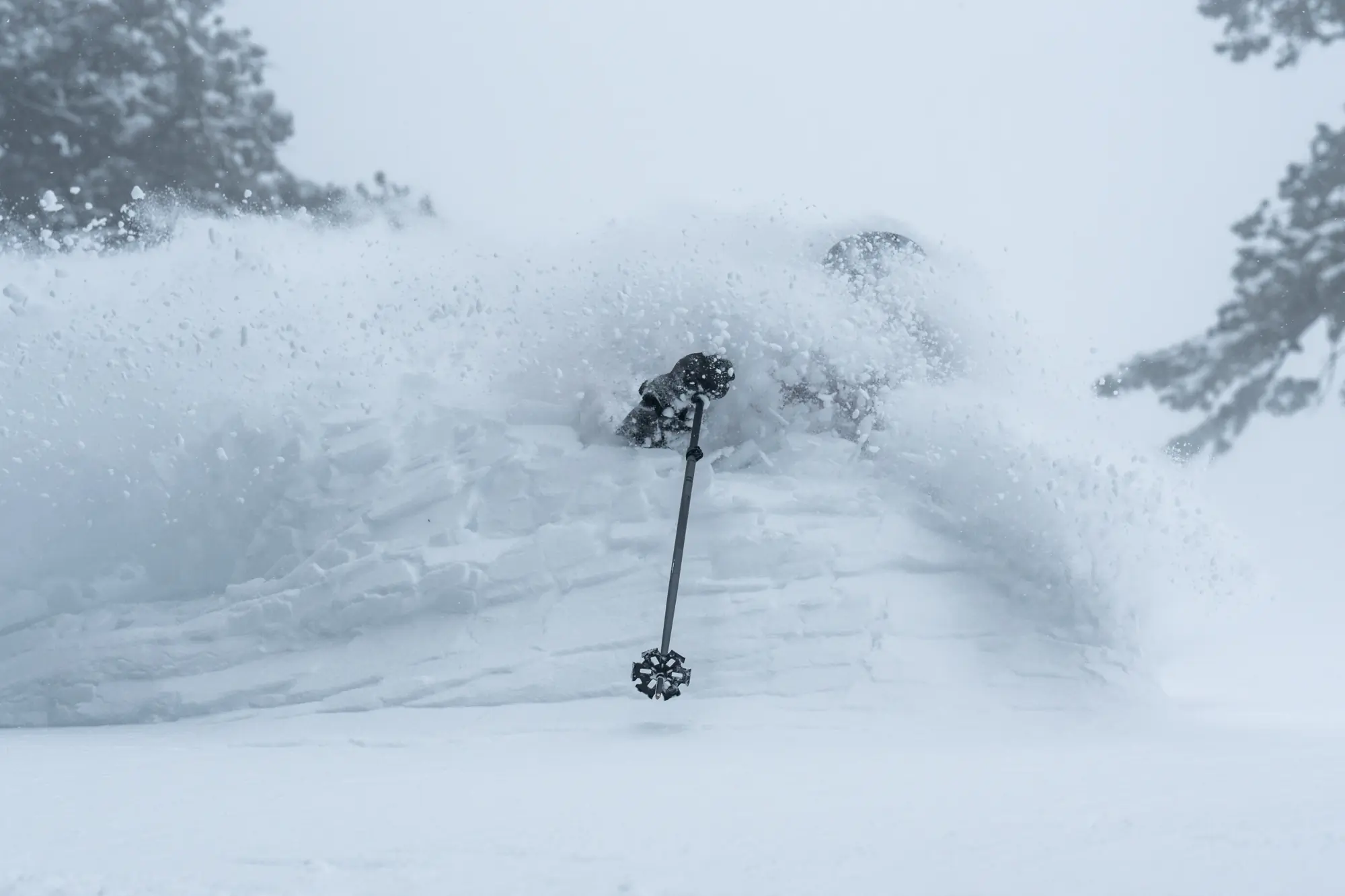 Snow flows over a skier at Powder Mountain
