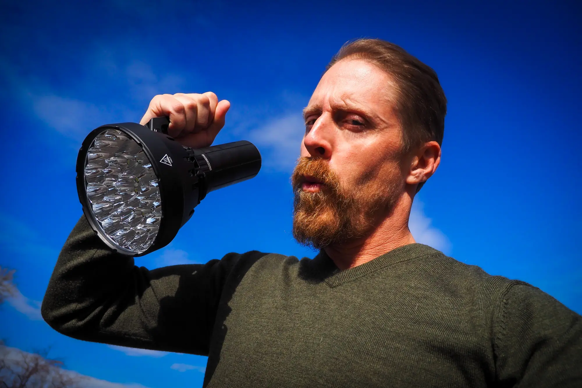 Sean McCoy holds an IMALENT SR32 flashlight