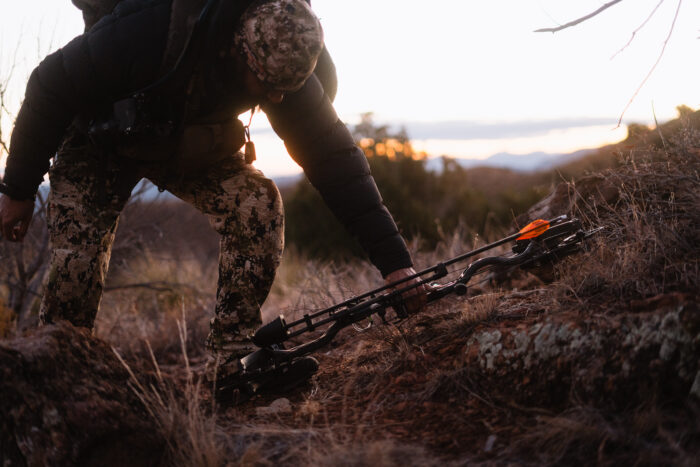 Hunter picking up his bow