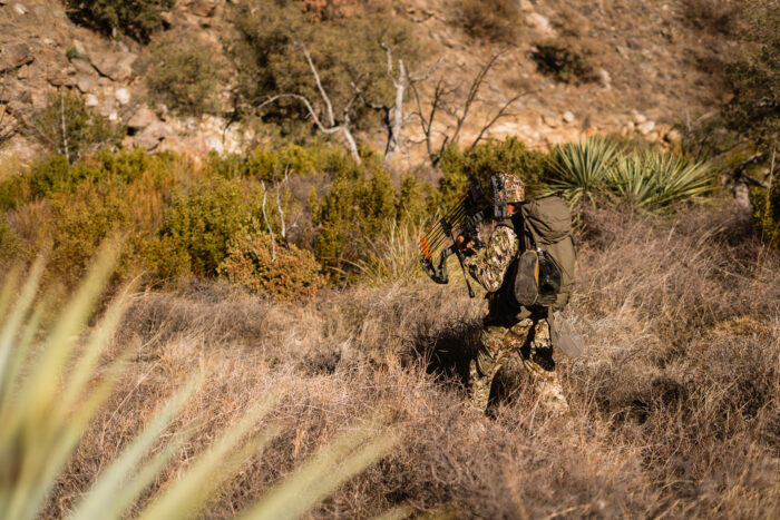 Hunter walking through the Arizona desert