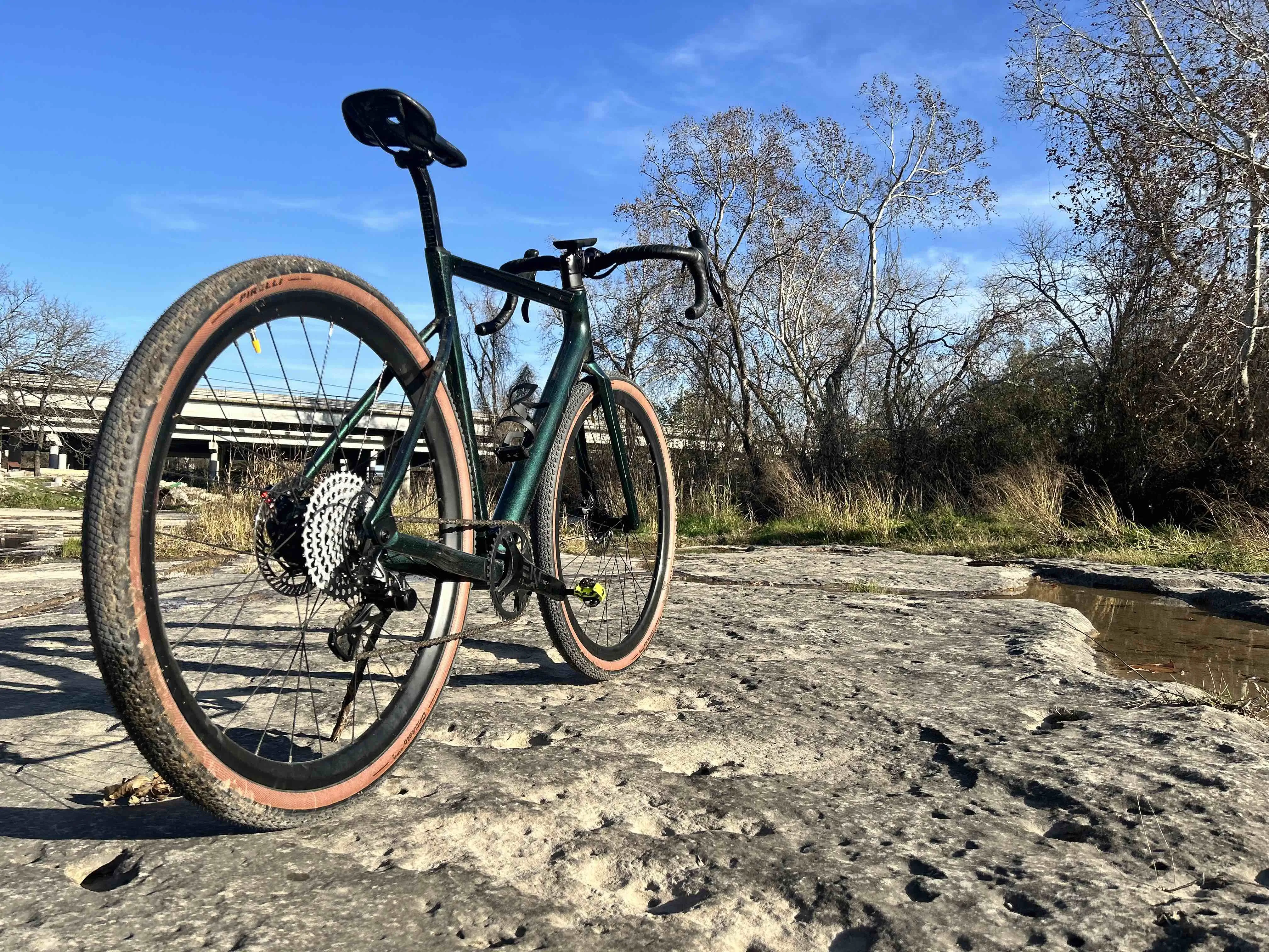 Desiknio X2 Gravel e-bike standing in a creek bed.