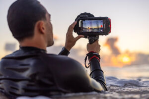 a man uses a waterproof phone case in the ocean