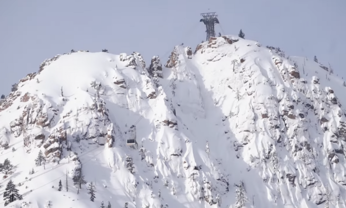 the base gondola ascending up steep terrain at Palisades Tahoe ski resort