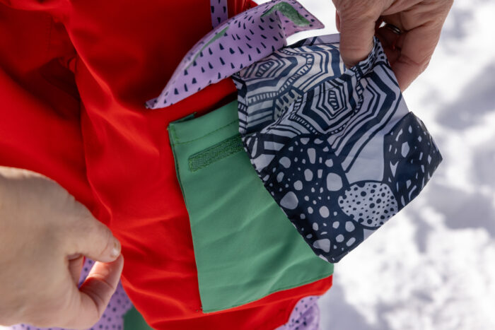 packable pouch that is inside a pocket on a winter jacket for kids 
